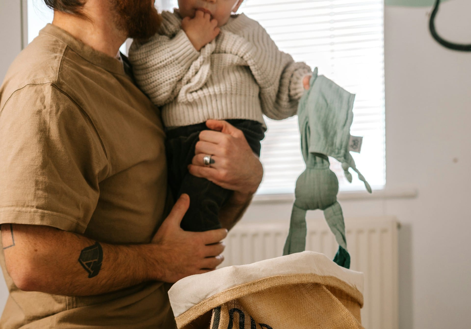 A parent holding their young child at home